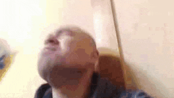 a close up of a man 's face with his eyes closed .