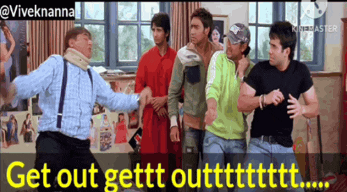 a group of men are standing in a room and one of them is wearing a neck brace .