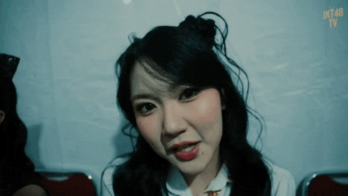 a close up of a girl with jk48 written on the bottom