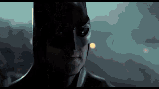 a close up of a person wearing a batman mask