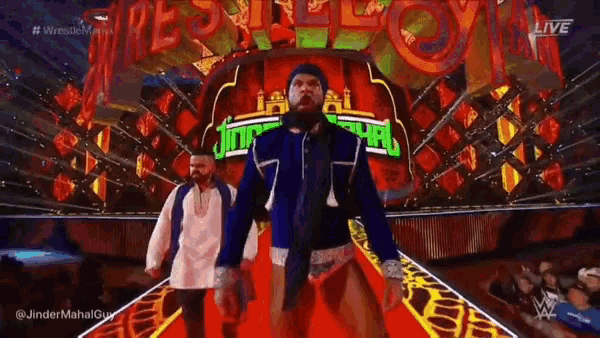 two men are walking down a red carpet in front of a sign that says ' reigns '