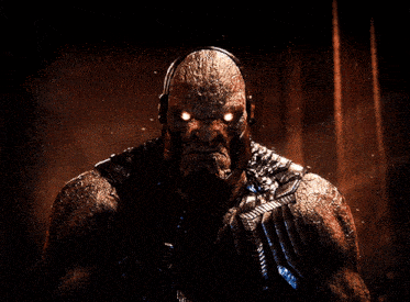 a close up of a man with glowing eyes looking at the camera