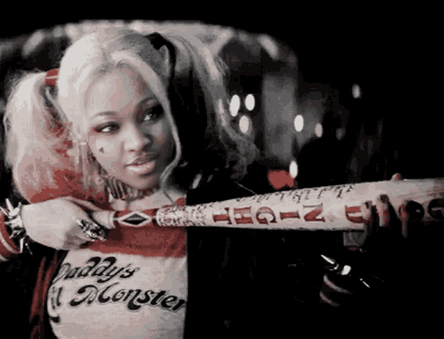 a woman in a harley quinn costume holds a bat