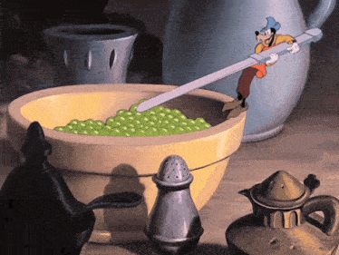 a cartoon of goofy holding a spoon over a bowl of green peas