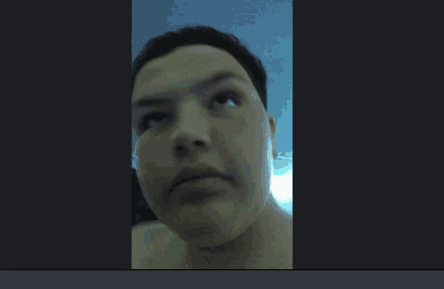 a close up of a person 's face with a gray background