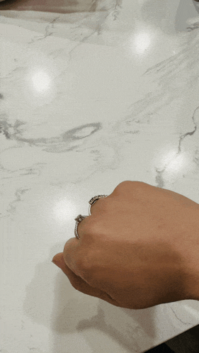 a close up of a person 's hand with a ring on