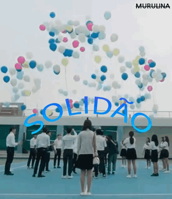 a group of people are standing in front of balloons that say solidao