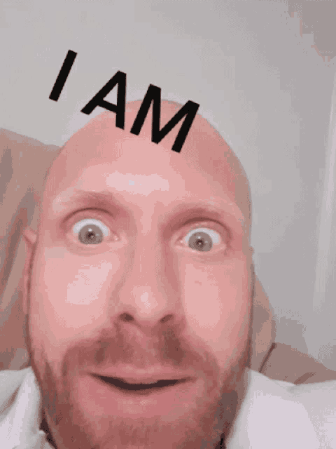 a bald man with a beard is making a funny face with the word retarded behind him