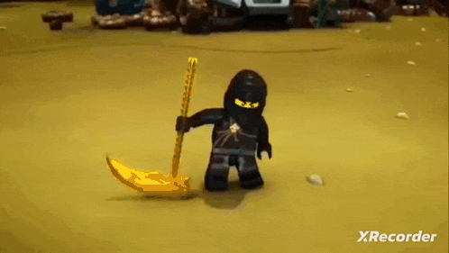 a lego ninjago character is holding a sword and a scythe .