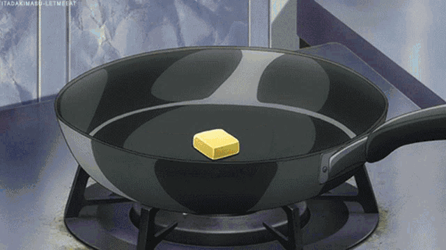 a piece of butter is being cooked in a frying pan on a stove