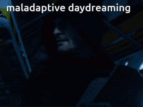 a man in a hooded jacket is holding a cell phone with the words maladaptive daydreaming behind him