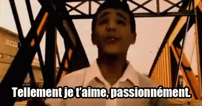 a man is standing in front of a bridge and says tellement je t 'aime passionnement .