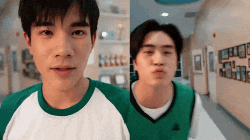 a man wearing a green vest and a white shirt is making a funny face