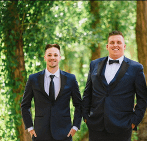 two men in tuxedos and bow ties are standing next to each other