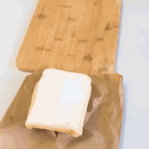 a piece of bread is sitting on top of a piece of paper