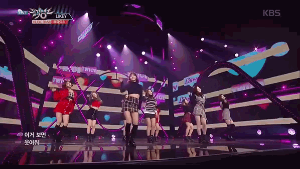 a group of girls are performing on a stage with a kbs logo