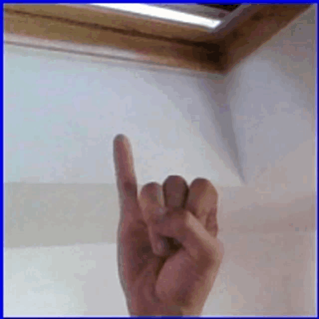 a person 's hand is shown with their index finger pointing up