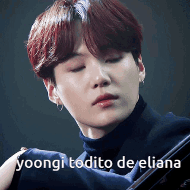 a close up of a person 's face with the words yoongi todito de eliana above it