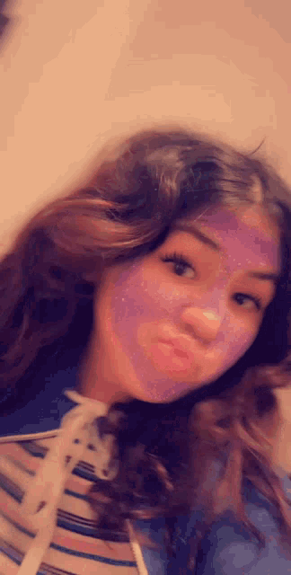 a girl with a purple face mask on her face .