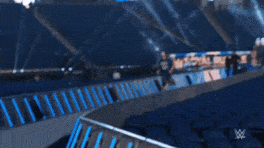 a man in a blue shirt is running down a ramp .