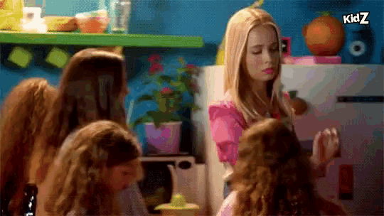 a group of girls are gathered in a kitchen with the word kidz on the bottom