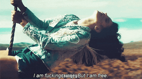 a woman swinging on a rope with the words " i am fucking cringey but i am free "