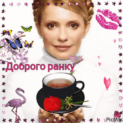 a woman is holding a cup of tea with a red rose on the saucer
