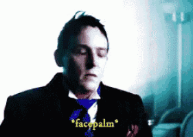 a man wearing a suit and tie says facepalm