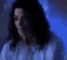 a close up of a person 's face with a blue background