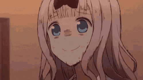 a girl with pink hair and blue eyes is smiling and making a funny face .