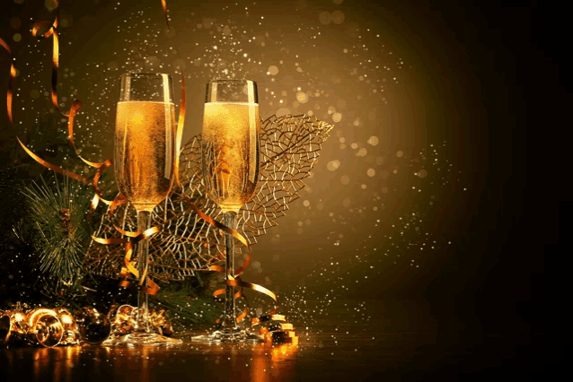 two glasses of champagne surrounded by gold ribbons and decorations
