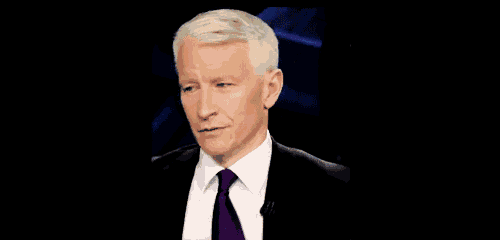 a man in a suit and tie looks at the camera with a serious look on his face