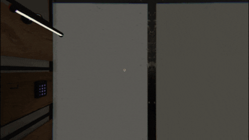 a computer screen shows a person walking down a hallway with a clock that reads 7:31