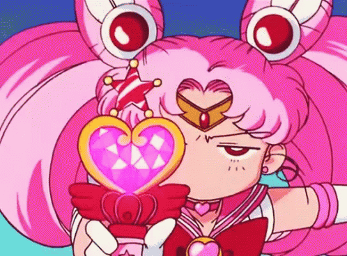 a cartoon girl with pink hair is holding a heart shaped object in her hand .