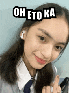 a girl wearing ear buds and a tie has the words oh eto ka on her face