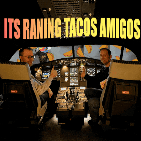 two men are sitting in a cockpit with the words " its raning tacos amigos " above them