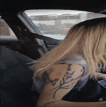 a woman with a tattoo on her arm that says ' butterfly '