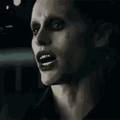 a close up of a person 's face with a joker mask on it .