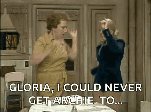 two women are dancing in a kitchen with the words gloria i could never get archie to