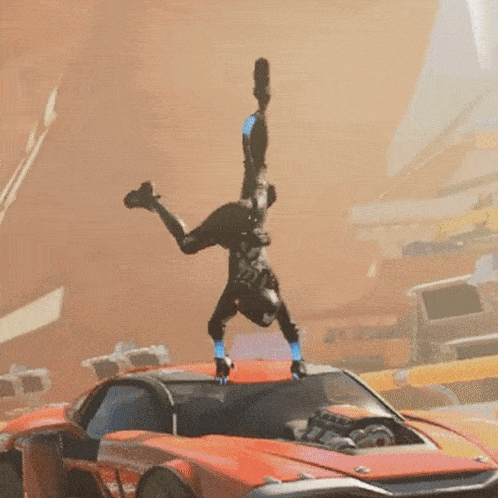 a man is doing a handstand on top of an orange car