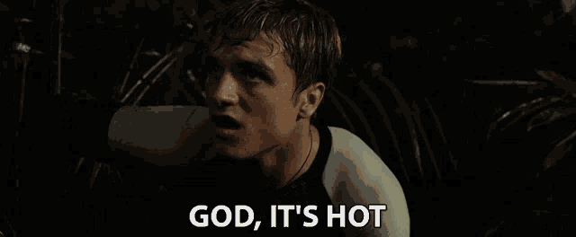 a man says god it 's hot in a dark room