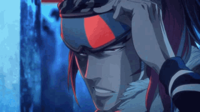 a close up of a person wearing a helmet with red and blue stripes