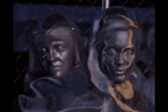 a couple of women standing next to each other in front of a chain link fence .