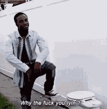 a man is squatting next to a toilet and saying `` why the fuck you lyin ? ''