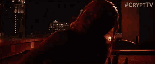 a woman is laying in a dark room with #crypttv written in the corner