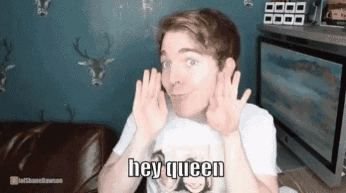 a man in a white shirt is making a face and says hey queen