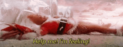 a man in a santa suit is laying on the ground and says `` help me , i 'm feeling ! ''