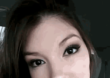 a close up of a woman 's face with her eyes closed while sitting in a car .