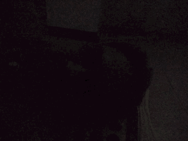 a dark room with a few lights on the wall