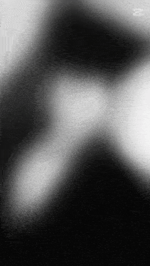 a black and white photo of a person 's face with a blurred background